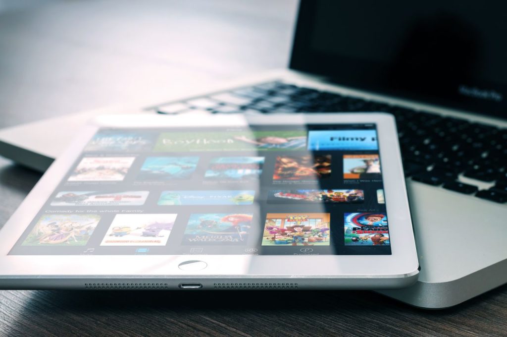 Services Tablet displaying streaming services on a laptop, illustrating digital entertainment setup.